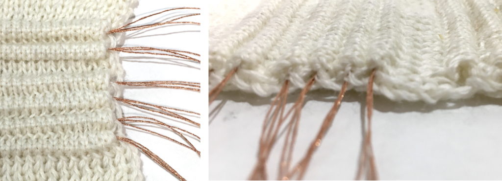 Photo of knit textiles with conductive thread placed within it.